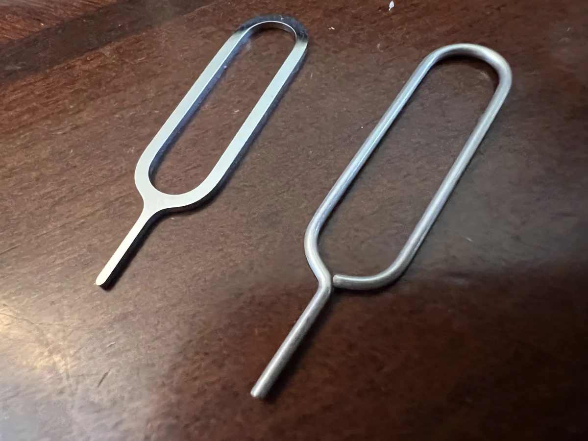 Two metal SIM card removal tools